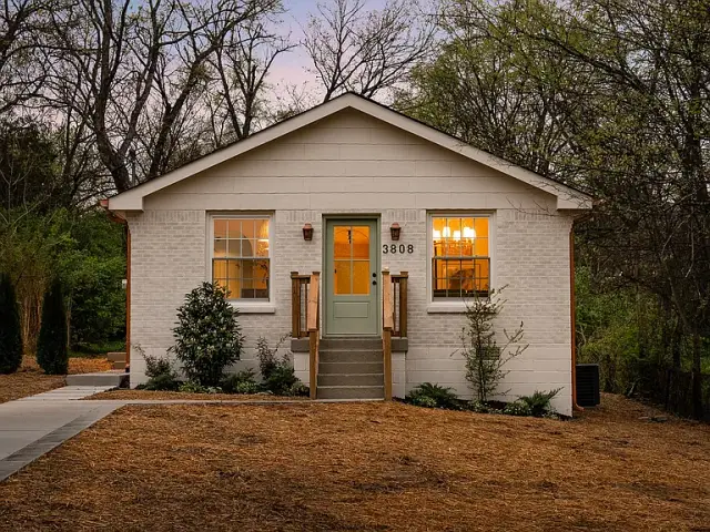Renovated white cottage at golden hour