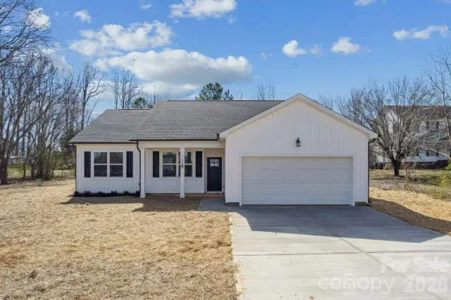 New white cottage with board-and-batten siding