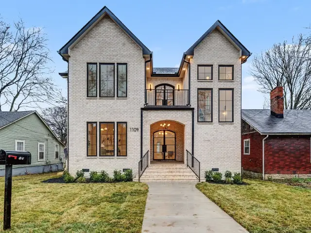 White-brick contemporary with arched entry