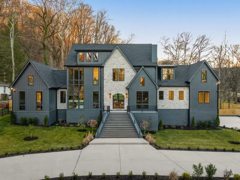 Modern luxury build with stone-and-siding facade